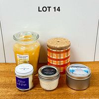 Front view of all five candles showing container types and labels