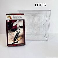 Boxed Turning Leaf air pressure cork popper positioned beside clear acrylic wine rack