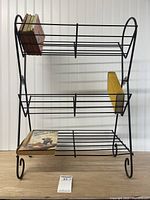 Full view of black wire shelf with books