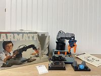 Robotic arm, accessories, manual and torn box displayed