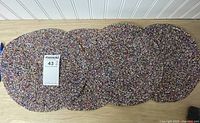 All six round seed bead placemats laid out side by side with size reference card