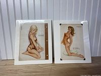 Two shrink-wrapped Vargas prints on backing boards
