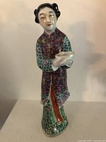 Front view of entire famille rose porcelain statue