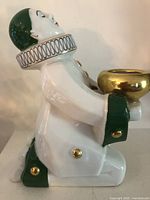 Left side profile showing enamel details and gilded buttons