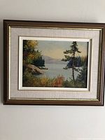 Framed oil painting on wall showing full view