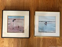 Both framed prints side by side on floor