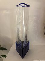 Full front view showing clear body and blue base