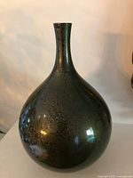 Full view of vase front showing bulbous form and patina