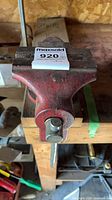 Top view of red cast iron bench vise mounted on workbench