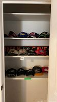 Closet shelves with multiple caps and Flyers sign