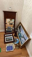 Group shot showing mirror, painting, mini clock, framed photos, plate and tile