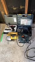 Group shot showing two hard cases (soldering kit, rotary tool kit) and two corded jigsaws