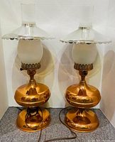 Front view of both copper lamps unlit