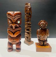 Front view of all three wooden sculptures