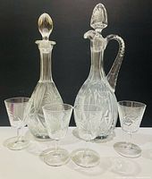 Group view: two decanters with stoppers and four wine glasses