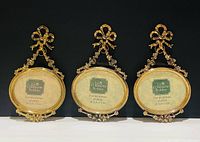 Front view of three matching oval gold-tone frames