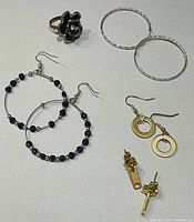 All items grouped: ring, four earring pairs