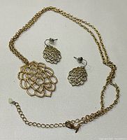 Necklace with pendant and matching earrings displayed