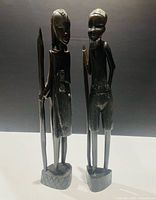 Front view of both ebony figurines standing upright