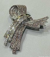 Front view of rhinestone bow brooch