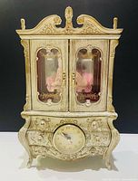 Front view showing entire jewelry box with clock and doors closed