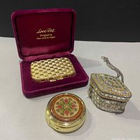 Group shot of six items including VCA compact in box, round cloisonné pill box, mother-of-pearl pill box