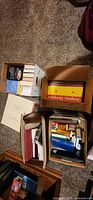 Overview showing multiple boxes with AA books, binder and assorted literature