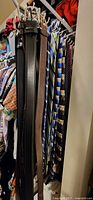 Belts and ties hanging on closet rack