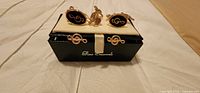 Front view of presentation box with two cufflinks and tie tack on display pad