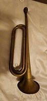 Full view of brass bugle showing entire length and bell