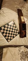 Marble chess board and wooden storage box with pieces