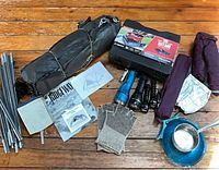 Entire lot layout including tents, stove, poles, flashlights, gloves, bowl, ladle