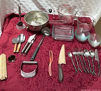 Overall layout showing glass measuring cups, baking dishes, mixing bowl, utensils and flatware