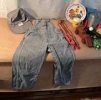 Full lot with overalls, cap and assortment of toys