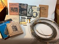 Group shot of all books, wire coil and hardware