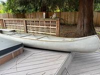 Full side view of aluminum canoe on deck