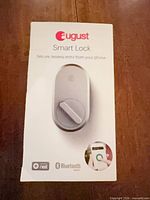 Front of sealed August Smart Lock retail package