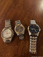 Group shot of three stainless steel wristwatches