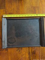 Top view of rectangular ceramic tray showing finish and measuring tape at 0-14 inches