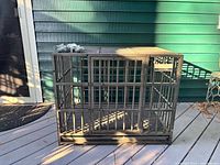 overall view of metal dog crate on deck