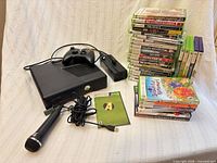 Overall lot: console, controller, microphone, power supply, AV/HDMI cable, two stacks of game cases