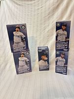 Five boxed Seattle Mariners bobbleheads displayed