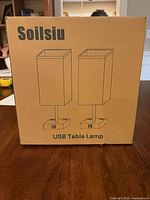 Front of sealed box showing Soilsiu USB Table Lamp graphics