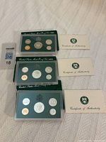 Three proof sets with sleeves and COAs displayed