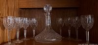 Waterford crystal decanter with stopper centered, eight wine glasses flanking