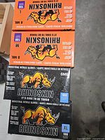 Black, orange and white glove boxes lined on table