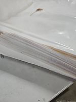 Close-up of edge of stacked white plastic bags