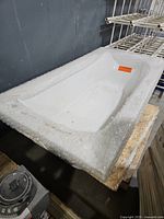 Top angled view showing overall bathtub shape and protective wrap