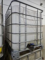 Full view of IBC tote in steel cage showing plastic tank