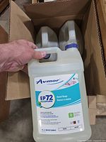 Front view of Avmor EP72 4 L hand soap jug in shipping box